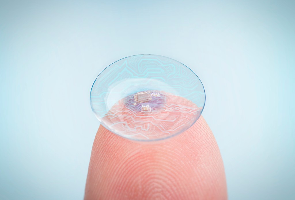 Futuristic contact lenses with digital and biometric implants integrated into the fingertips.