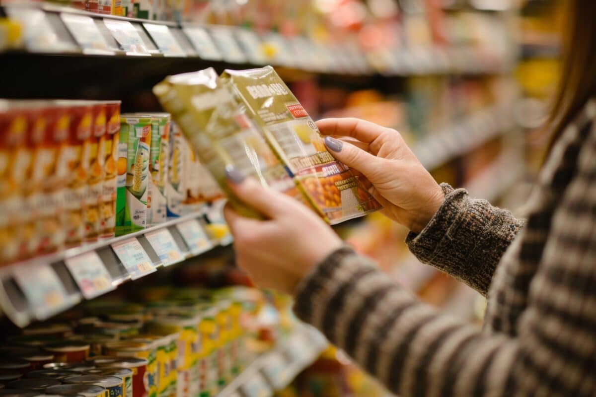 Woman holding packaged food at grocery store