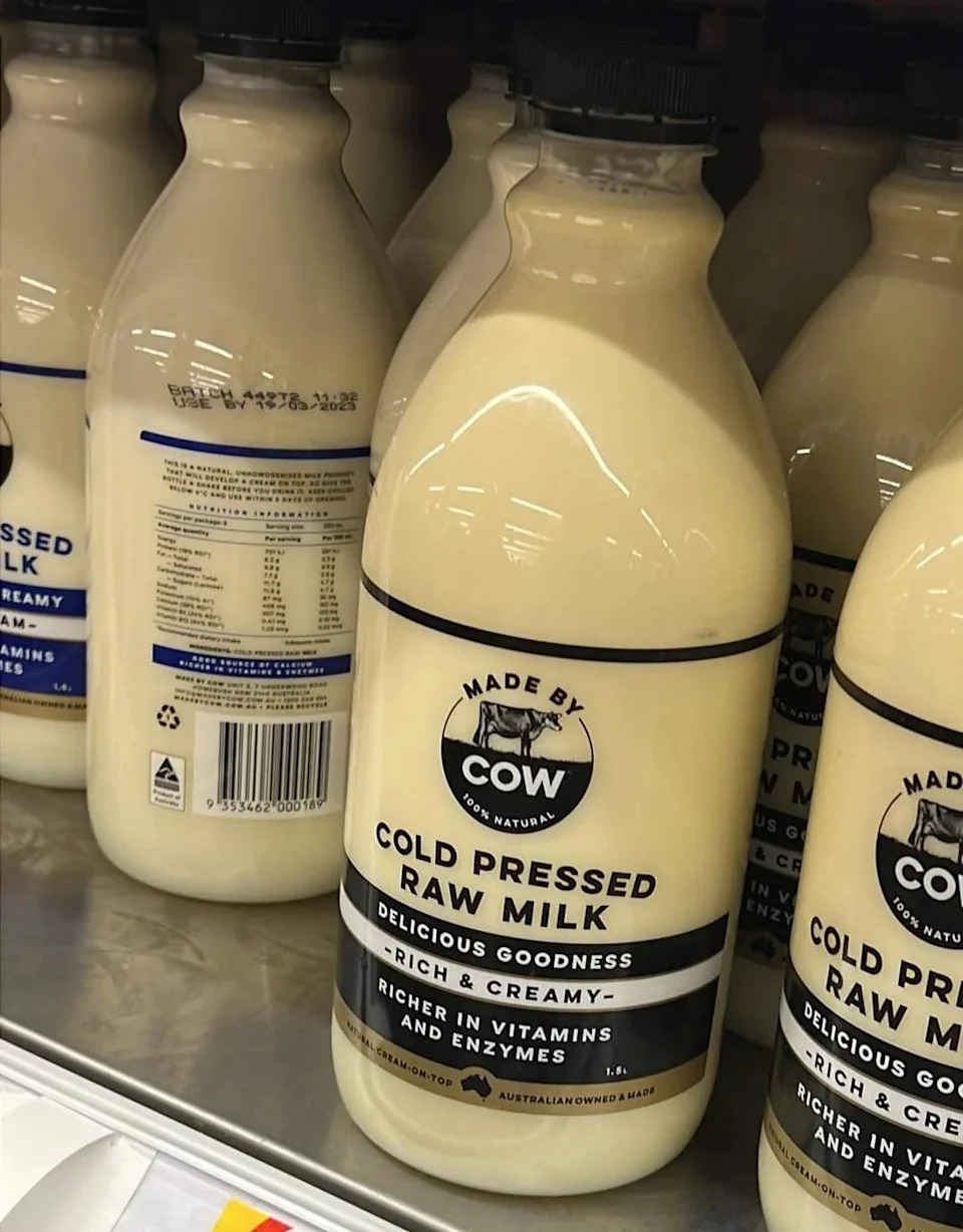 bottle of "made by a cow" Cold pressed raw milk on store shelves