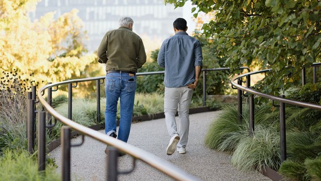 Two friends walk down the winding streets of Manhattan's High Line park.